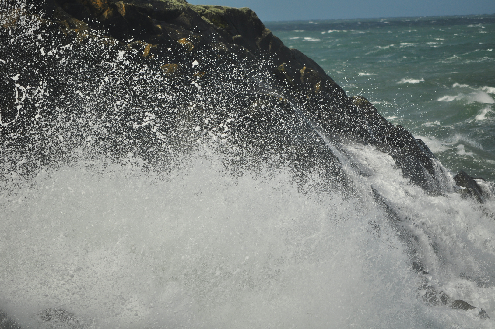 Die Wellen auf den Felsen in Wales