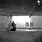 Double reflection of the accordion player in the underpass of Bordighera station 