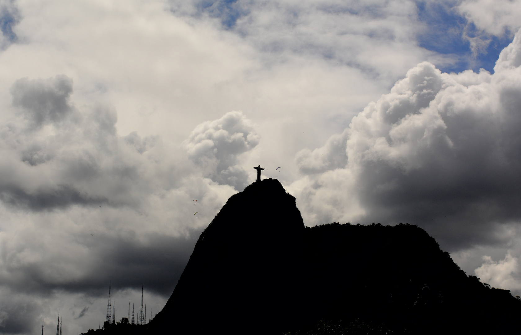 Dramatic clouds and paragliders over Christ the Redeemer in Rio