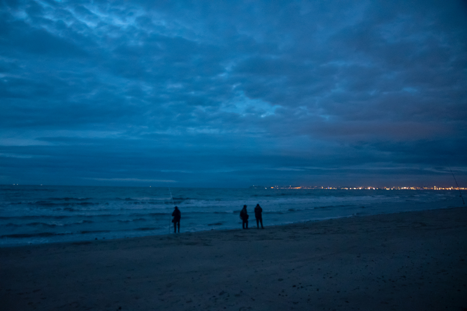 Drei Männer am Strand