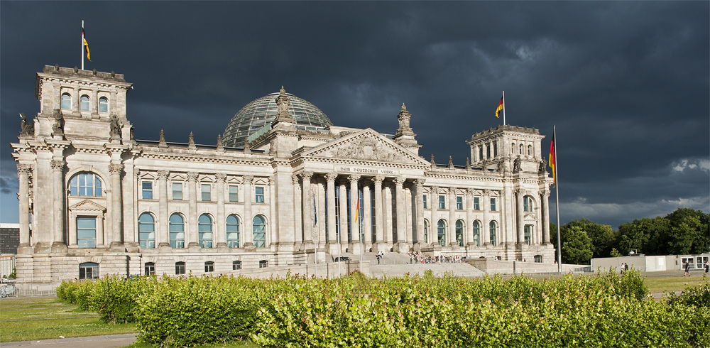 Dunkle Wolken über dem Reichstag während sich im Westen die Sonne neigt...