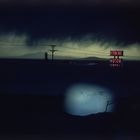 E. Haas - 1978 A cloudy night sky over the Western Skies Motor Motel in Colorado.