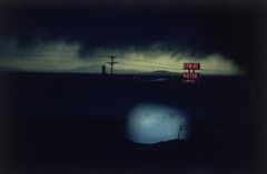 E. Haas - 1978 A cloudy night sky over the Western Skies Motor Motel in Colorado.