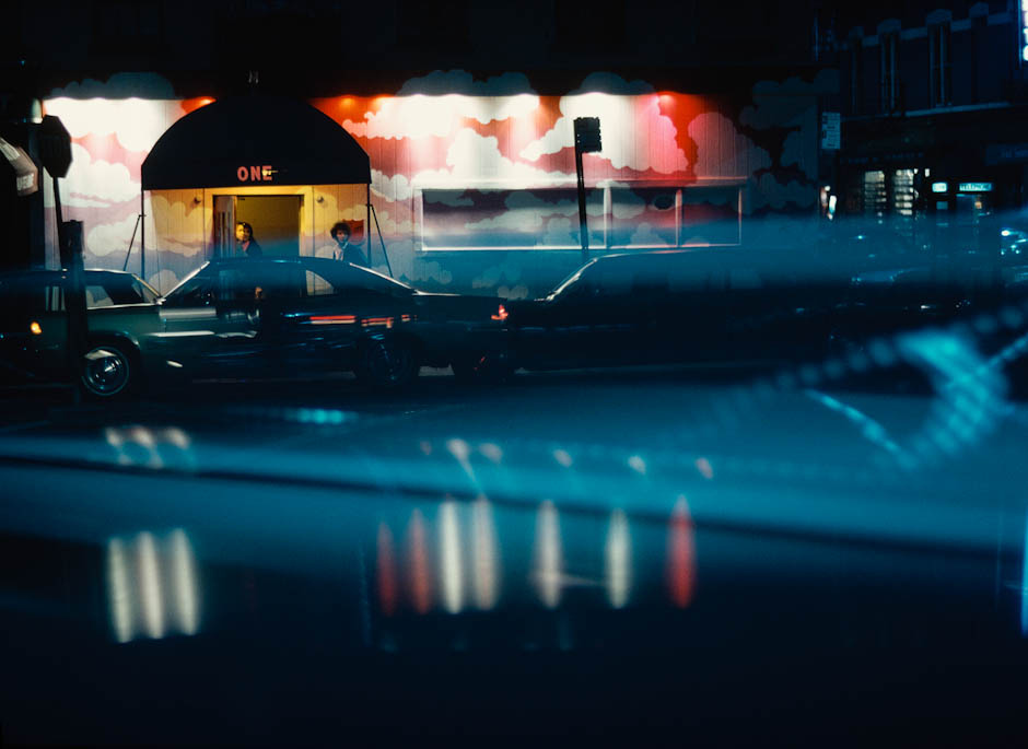 E. Haas - June 1968 Cars outside an entrance way seen through a windscreen at nightime.