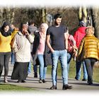 Ein junger Mann mit drei Frauen auf einem Spaziergang.