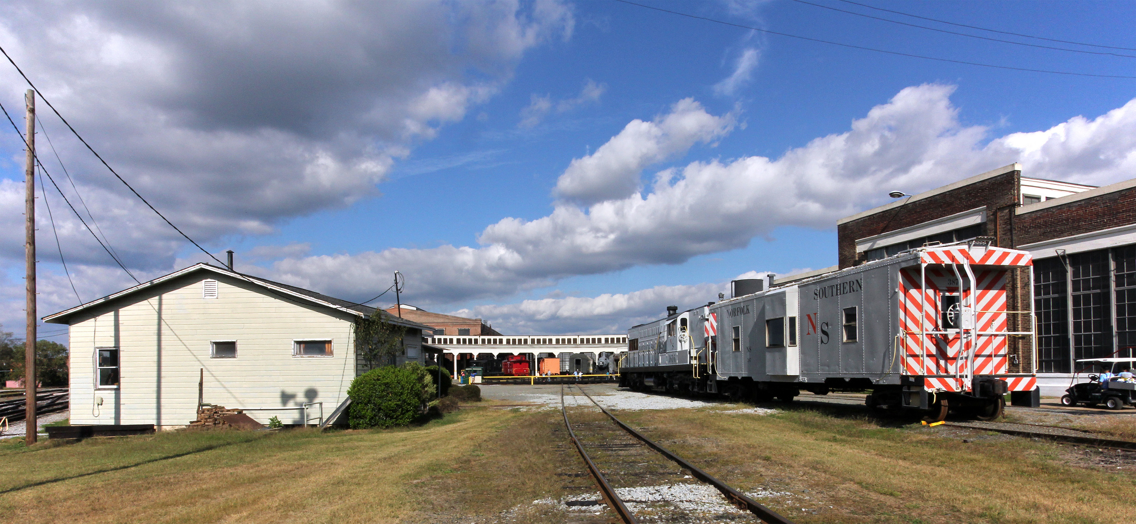 Eine Fairbanks Morse AS-416 mit Bay Window Caboose vor dem Roundhouse des NCTM