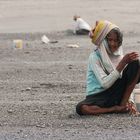 Elder women collecting black stones@East Bali, Indonesia