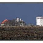 Farm buildings against storm clouds