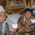 Father and son drinking tea with horse milk