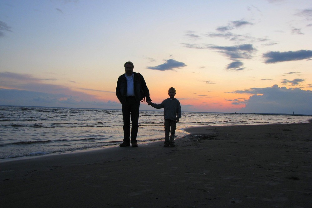 Father and son on the evening beach....