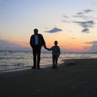 Father and son on the evening beach....