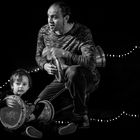 Father and son playing darbuka