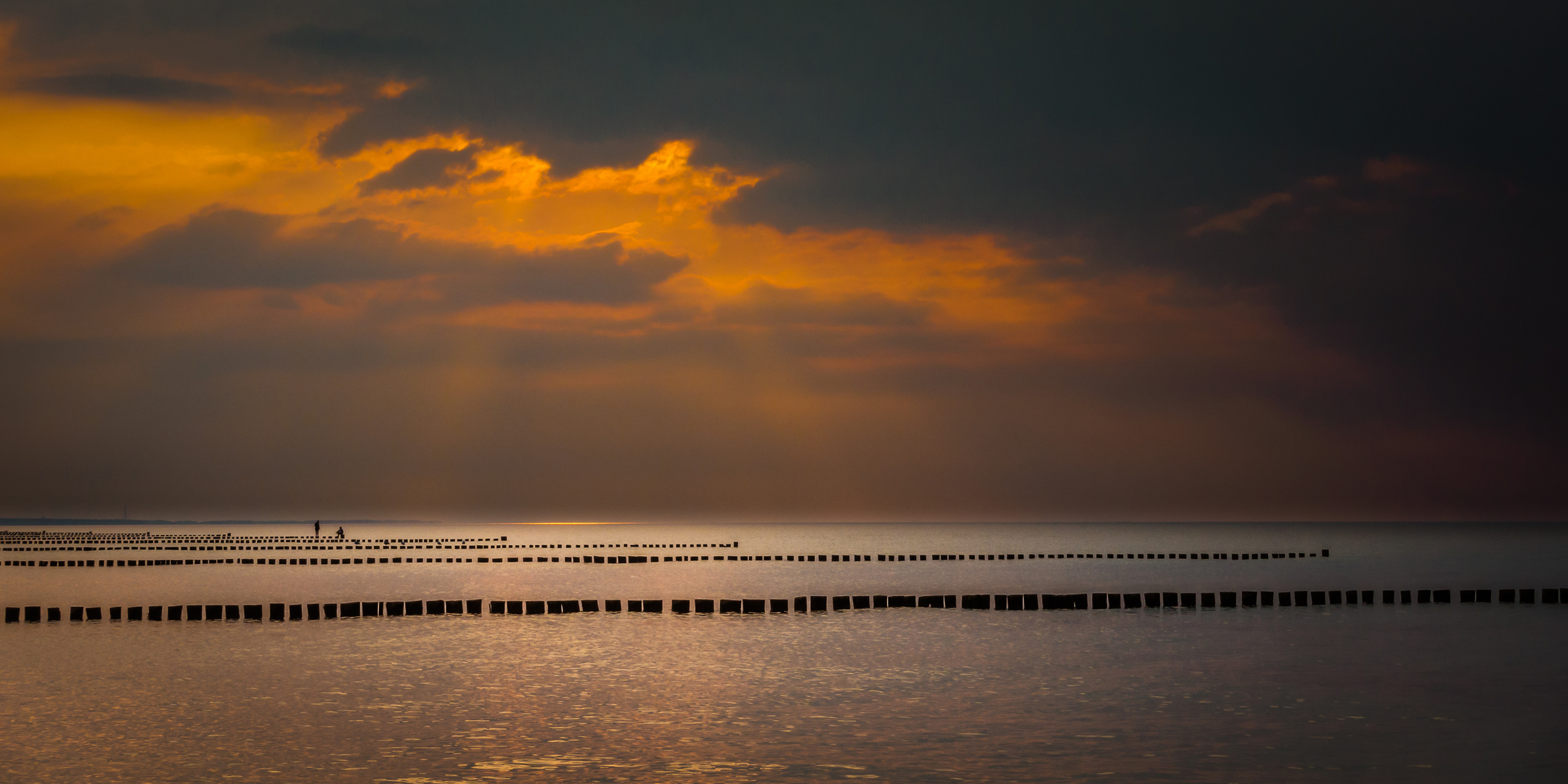 Fehmarn- Pfahlsitzen zum Sonnenuntergang