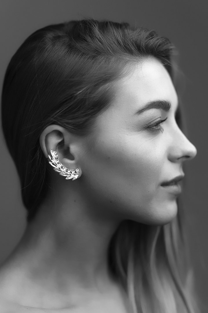 female profile with silver jewelry