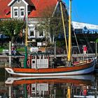 Fischerhaus und Kutter im Hafen von Neuharlingersiel