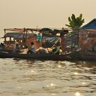 Fisher come home to their floating house on the Tonlé Sap river