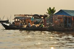 Fisher come home to their floating house on the Tonlé Sap river