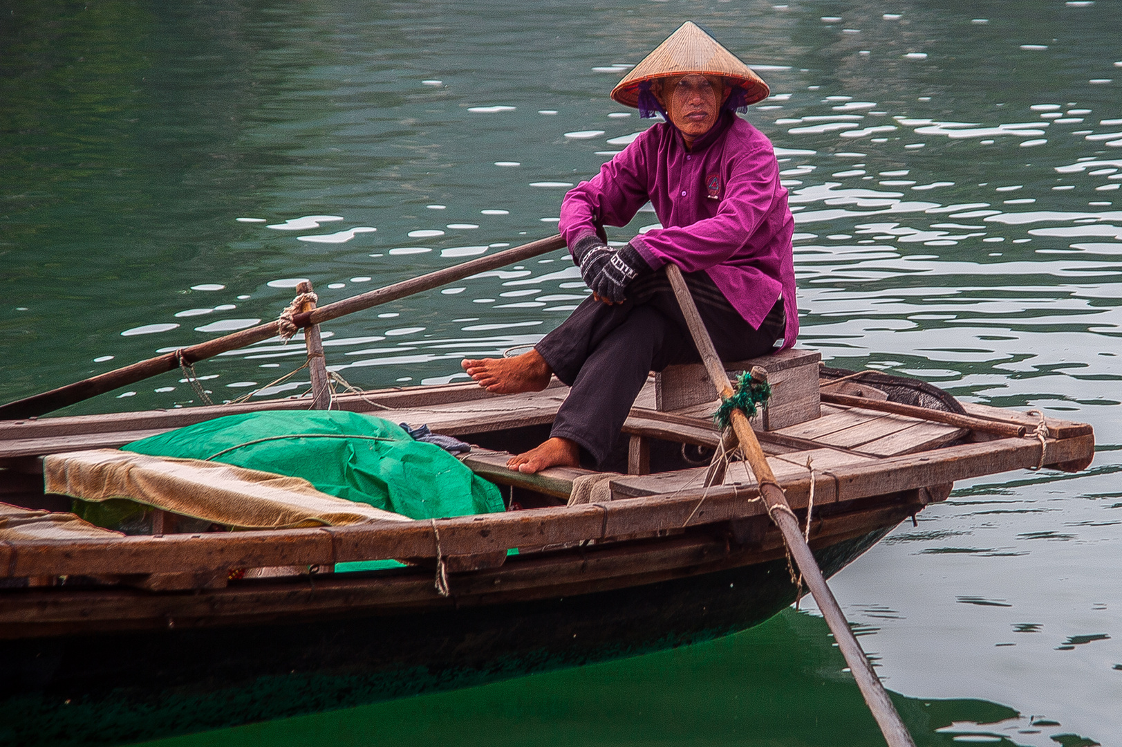 fisher woman rows out selling souvenirs