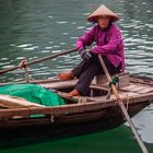 fisher woman rows out selling souvenirs