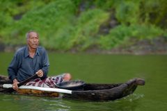 Fisherman goes out in a dugout canoe nearby Trunyan