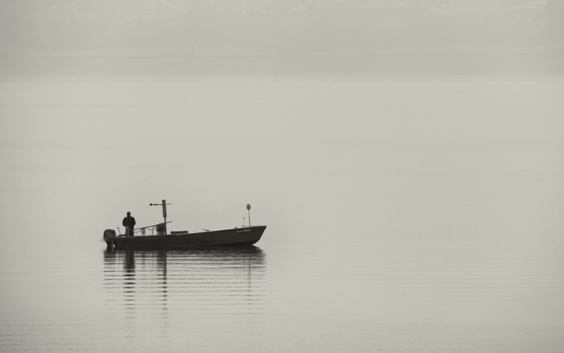 Fisherman in the early morning fog