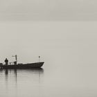 Fisherman in the early morning fog