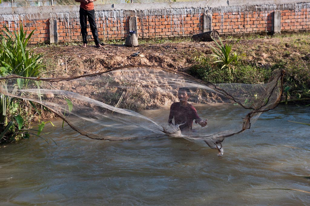 Fisherman throwing a net