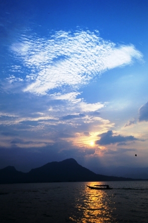 ***Fishermen on Lake Jatiluhur with Giant 'Eagle' Cloud