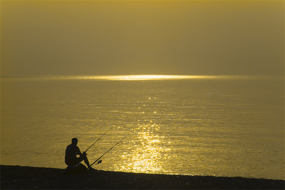 Fishing at dawn on Olympus beach