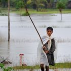 Fishing boy in the rain