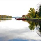 Flusslandschaft im Herbst mit roten Leichtern