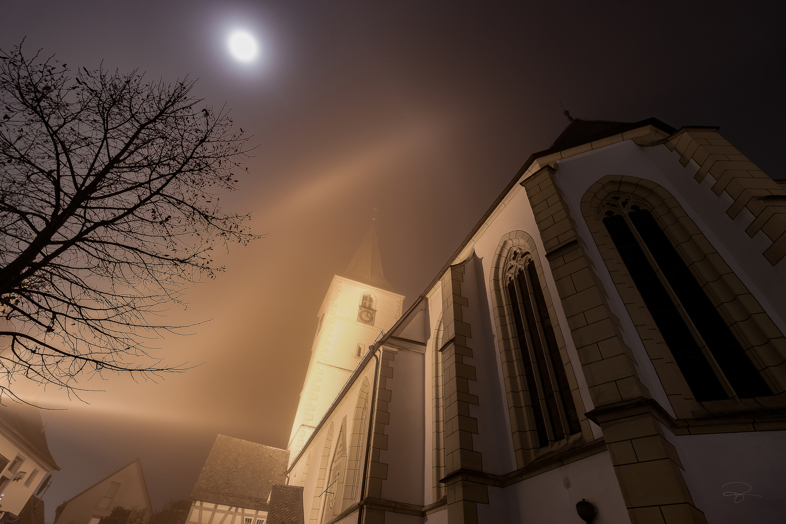 fog surrounds the church yard