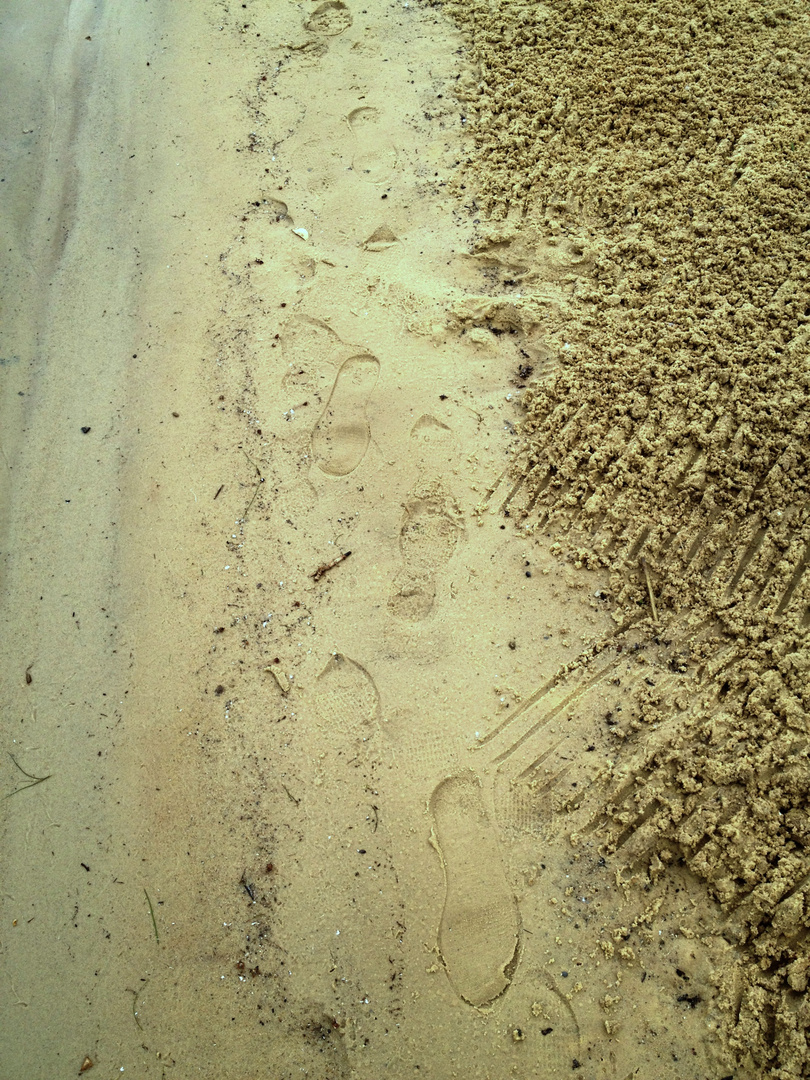Footsteps in the sand.