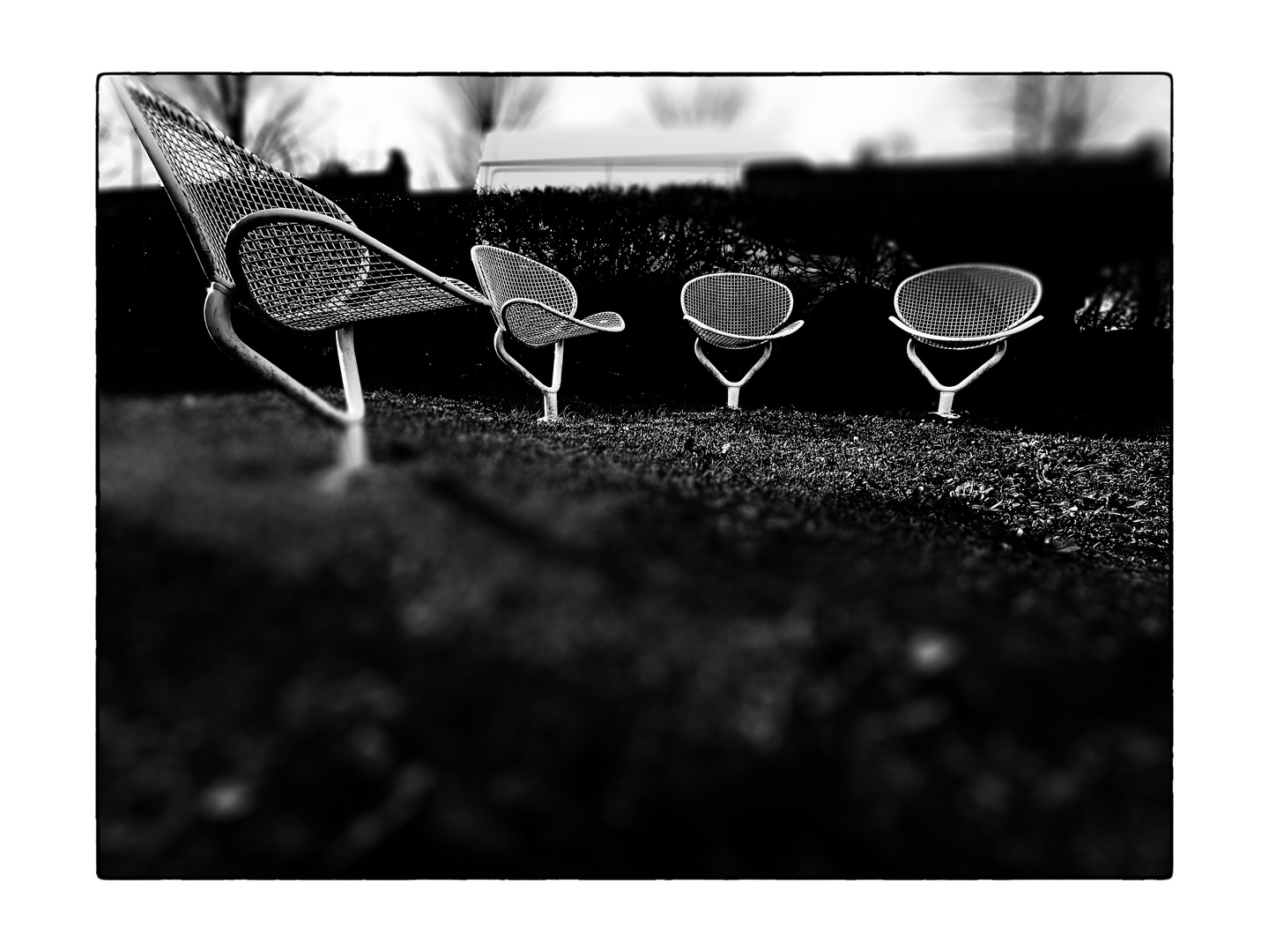 four white garden chairs