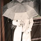 Frau mit Regenschirm in Regen