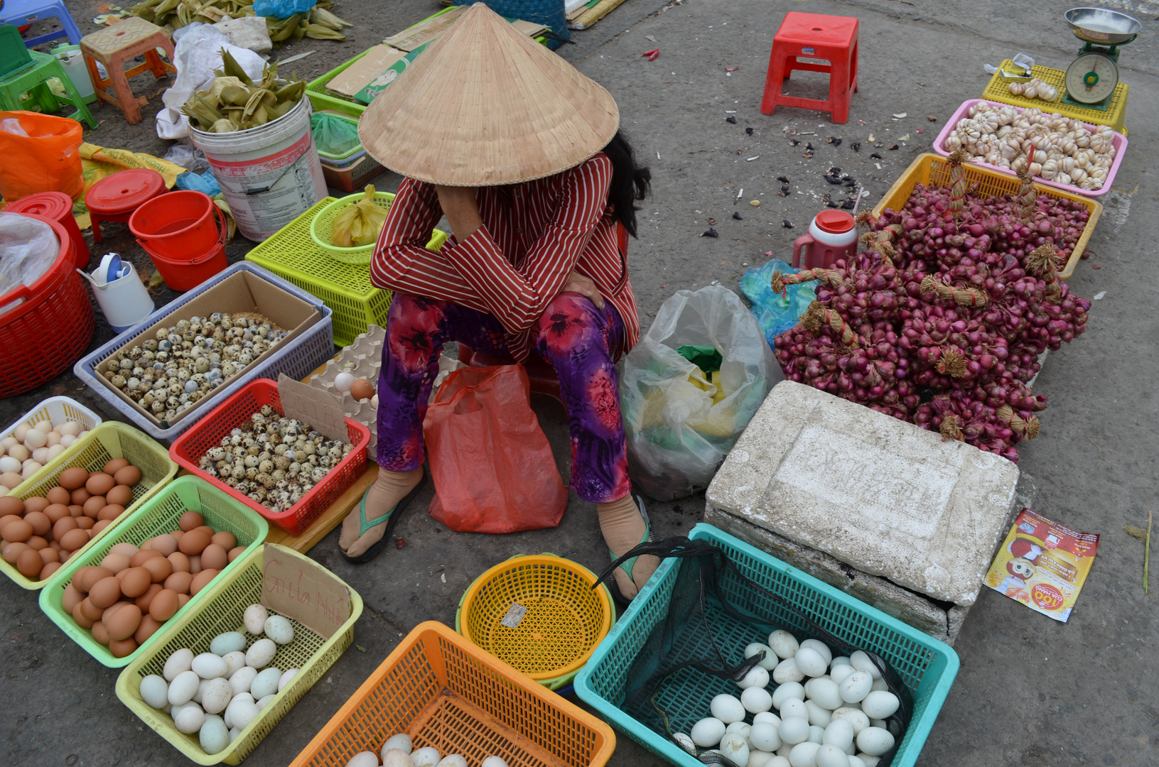 Frau mit verschiedenen Waren vor der Markthalle von Can Tho (Südvietnam) 