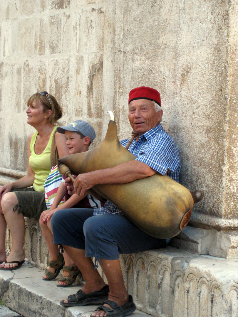 fröhlicher alter Herr mit Instrument - Kroatien, Trogir