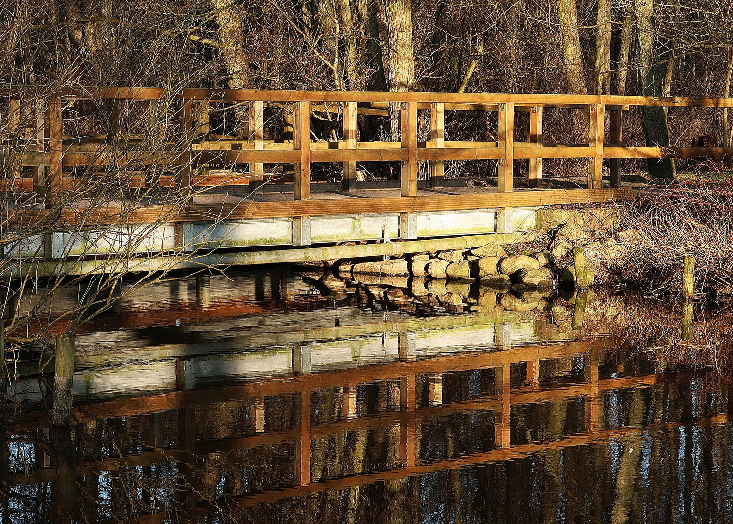 Früh morgens spiegelt sich die kleine Brücke 