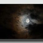 full moon framed by clouds