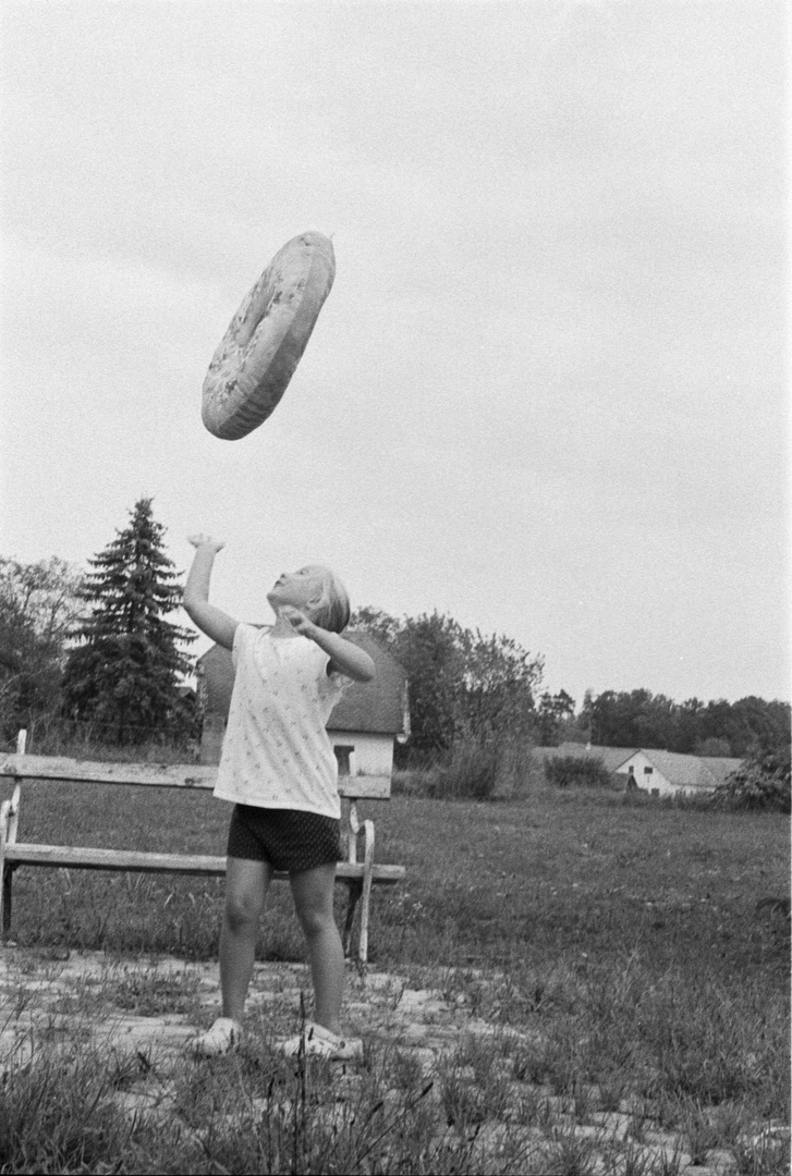 girl catching giant donut, 1978