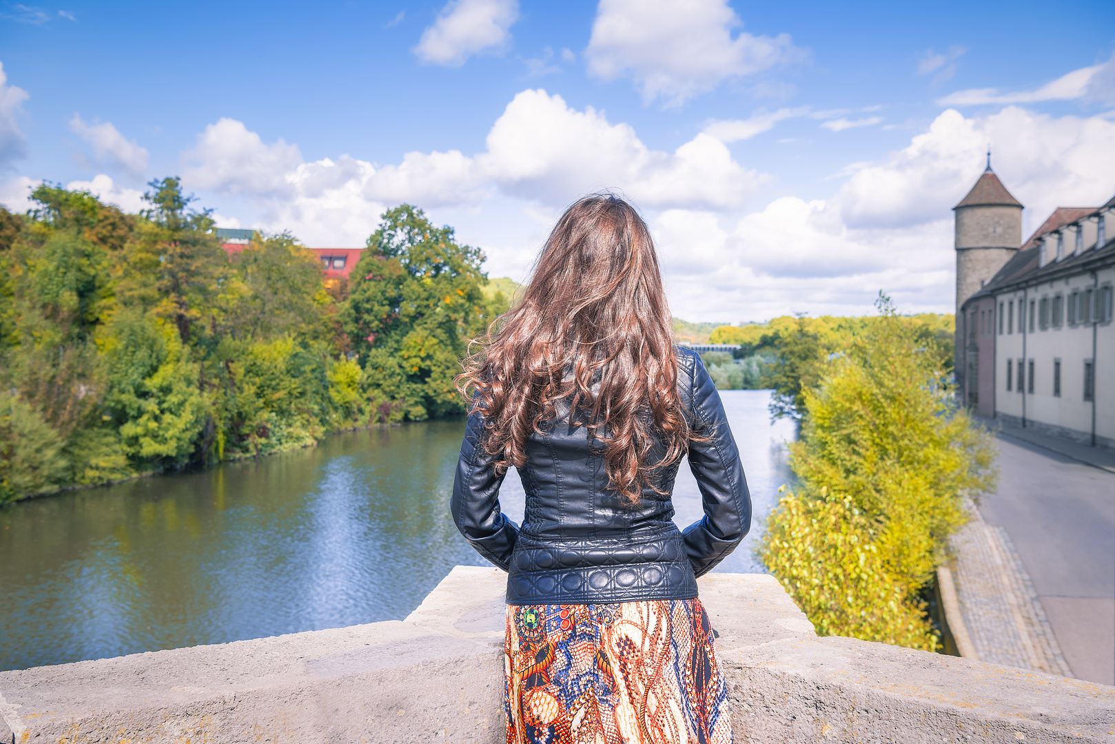 Girl looking toward the river and cloudscape