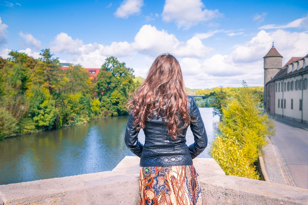 Girl looking toward the river and cloudscape