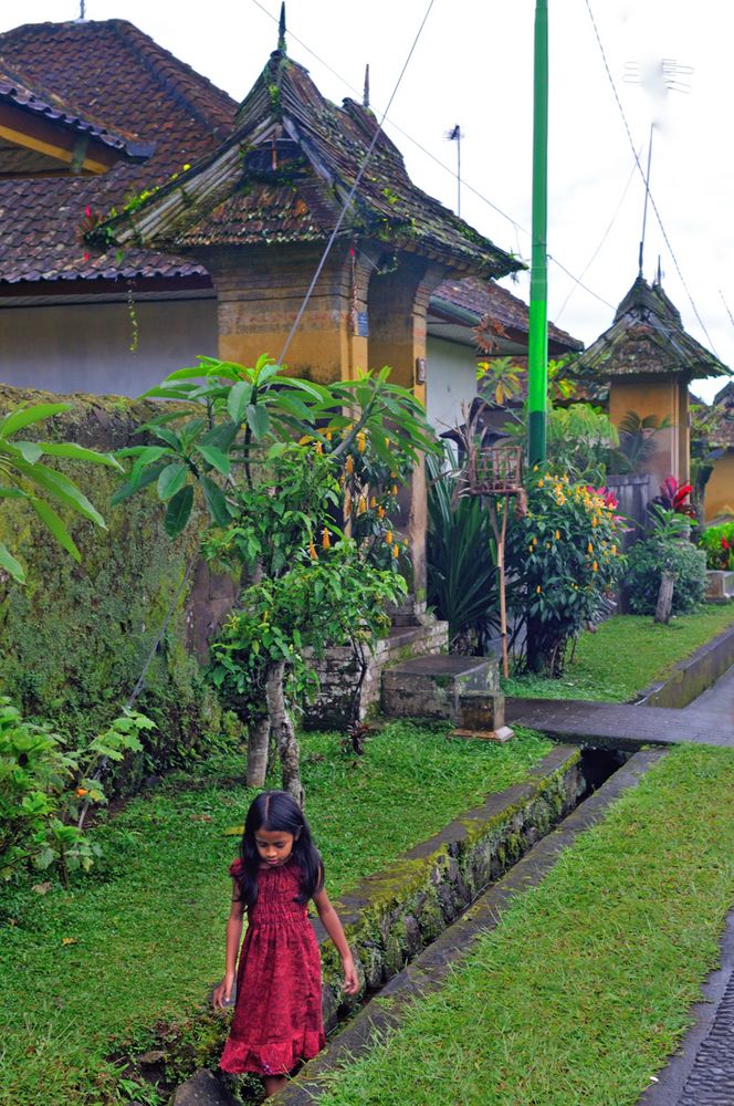 Girl playing in the sideway gutter