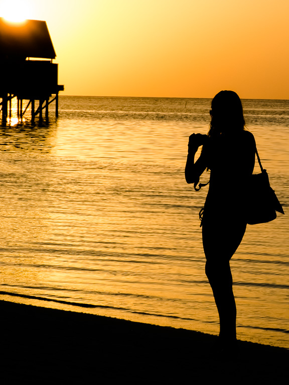 Girl taking photos of maldivian Sunset