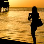 Girl taking photos of maldivian Sunset