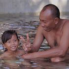 Girl taught by her father learns to swim