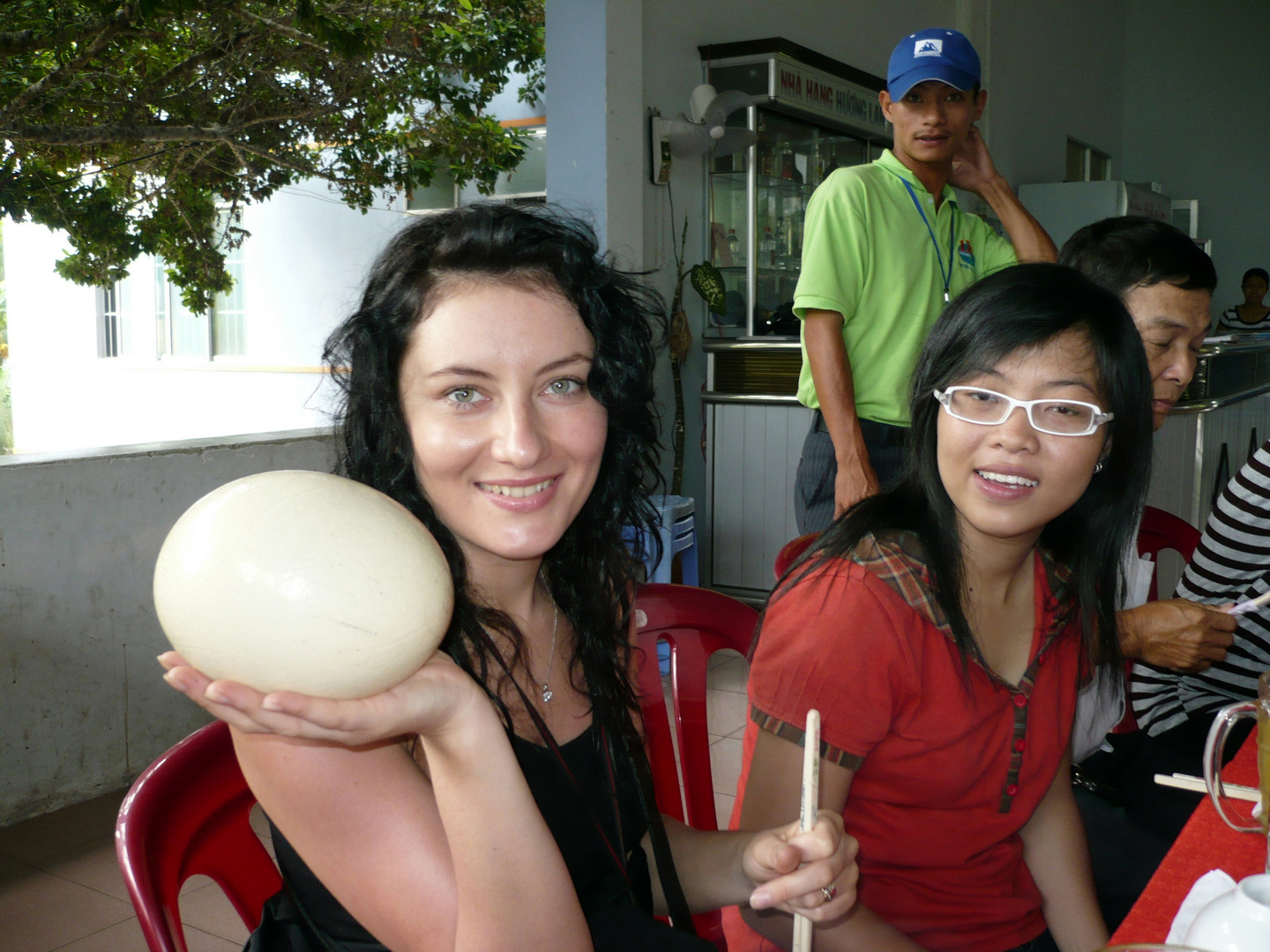 Girl with egg of ostrich