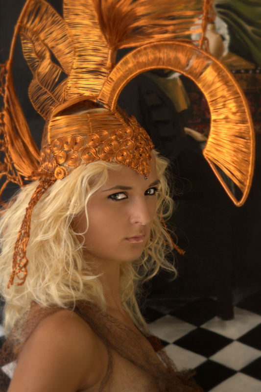 [girl with golden helmet in front of a painting]