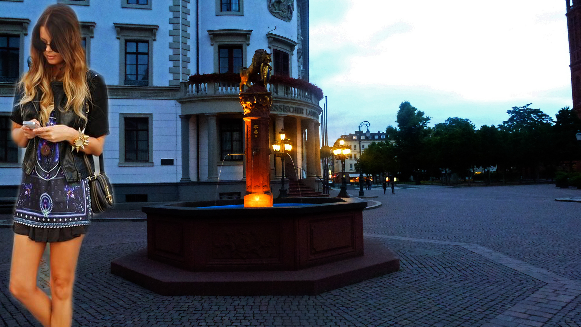 Girl with Mini Dress and Handy at a foutain in Wiesbaden