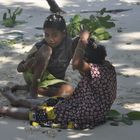 Girls decorating their hair with flowers